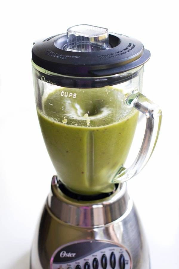 Peach green smoothie in a blender.