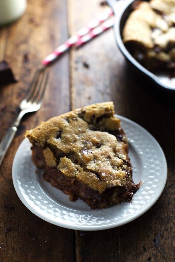 Deep Dish Chocolate Chip Cookie slice on a white plate.