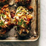Loaded BBQ Baked Potatoes on a sheet pan.