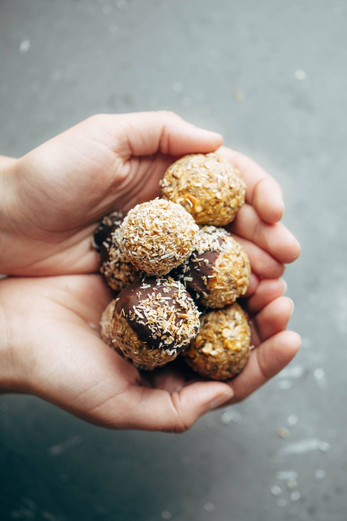 Hands holding energy bites.