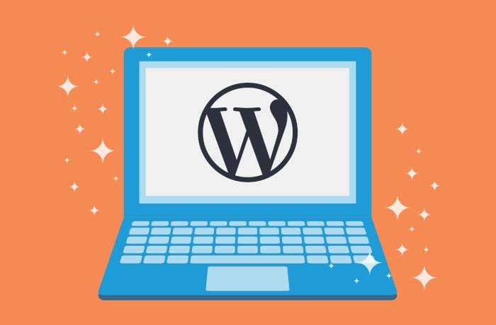 a computer on an orange background with the WordPress logo on screen