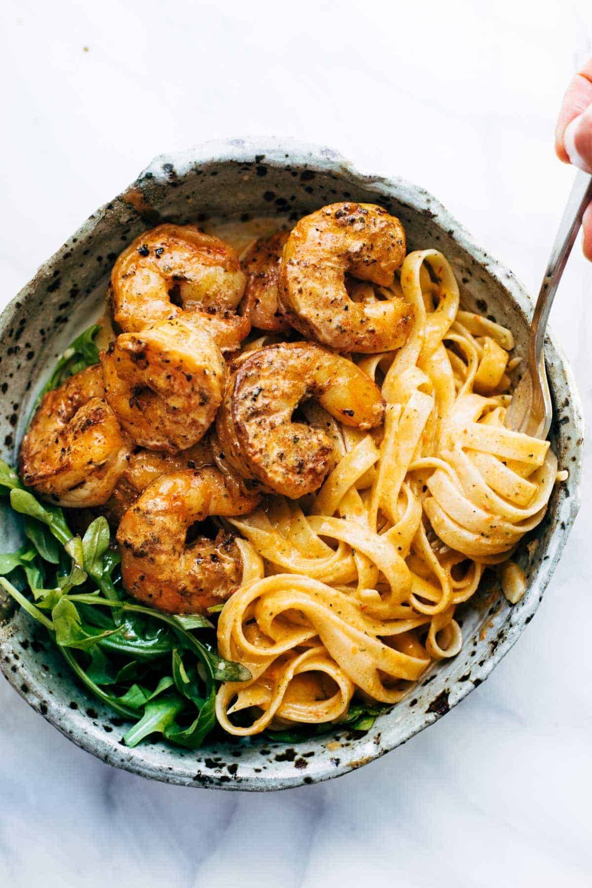 Red Pepper Fettuccine with Shrimp in a bowl with noodle twirl.