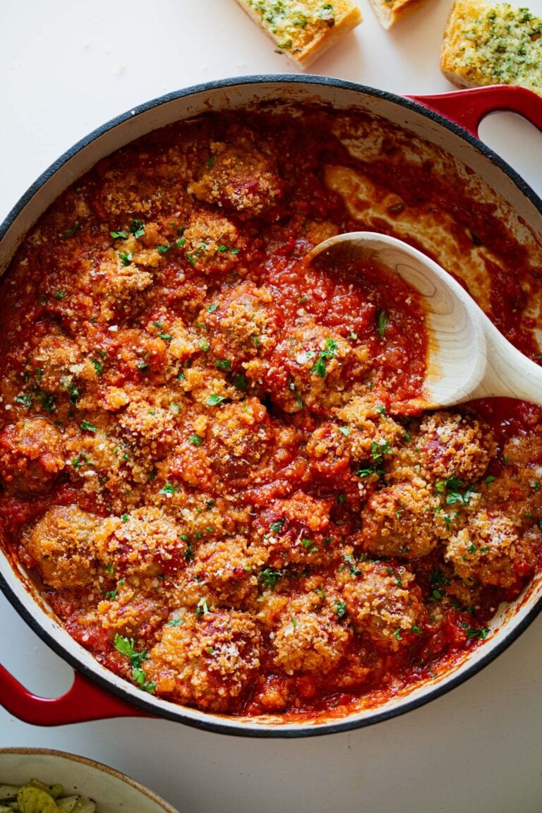 Ricotta meatballs in red sauce in a pan.