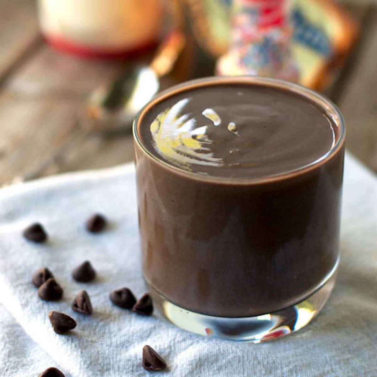 Double chocolate malt with bananas, tofu, almond milk, and cocoa in a glass with chocolate chips.